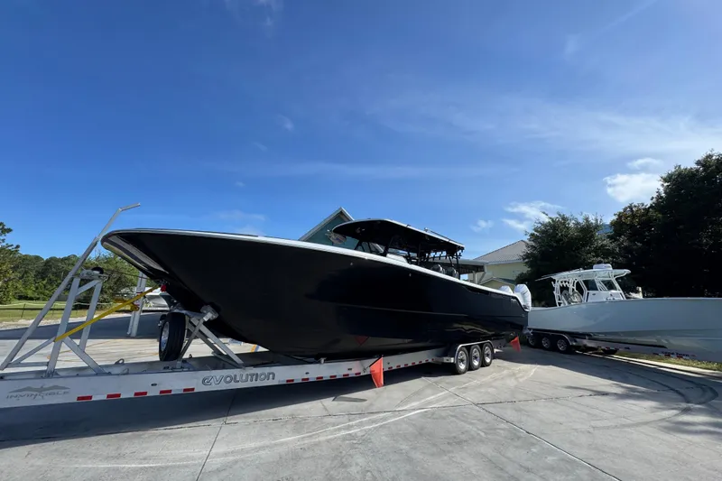 Slide: The Image of 2022 Invincible 46 Catamaran on trailer under clear blue sky. - 3