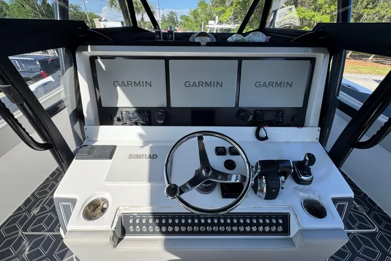 Slide: The Image of Helm of 2022 Invincible 46 Catamaran with Garmin displays and Simrad controls. - 30