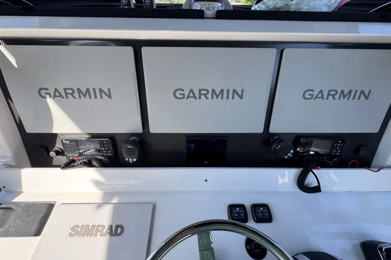 Slide: The Image of Helm of 2022 Invincible 46 Catamaran with Garmin displays and Simrad equipment. - 32