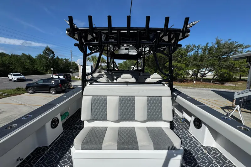 Slide: The Image of 2022 Invincible 46 Catamaran with sleek seating and modern design, docked outdoors. - 35