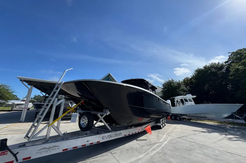 Slide: The Image of 2022 Invincible 46 Catamaran on trailer under clear blue sky. - 4