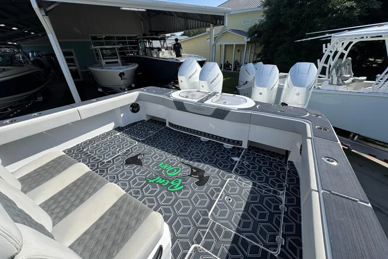 Slide: The Image of 2022 Invincible 46 Catamaran with stylish seating and powerful outboard engines. - 40