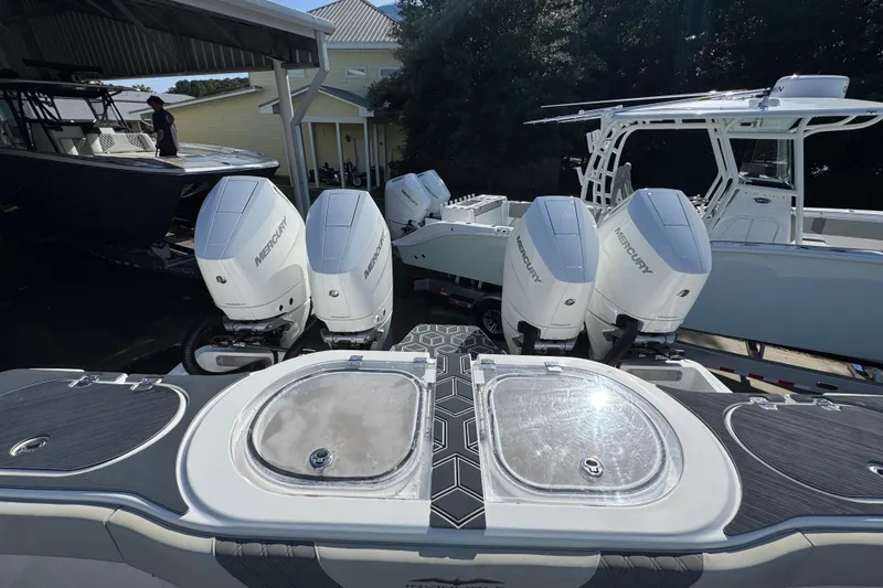 Slide: The Image of 2022 Invincible 46 Catamaran with Mercury outboard engines in a marina setting. - 44