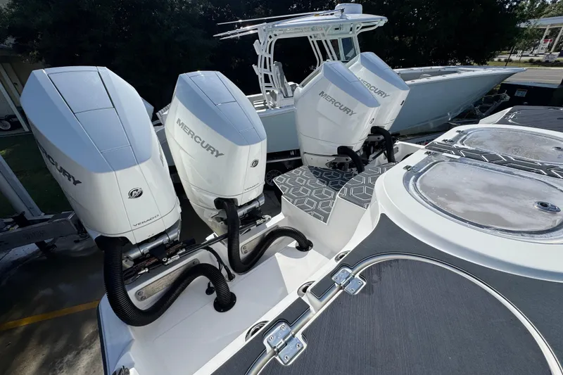 Slide: The Image of Four Mercury outboard engines on a 2022 Invincible 46 Catamaran, showcasing power and design. - 46