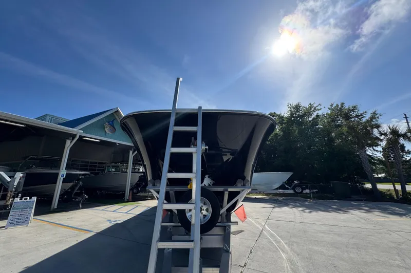 Slide: The Image of 2022 Invincible 46 Catamaran on trailer under bright sunlit sky. - 5