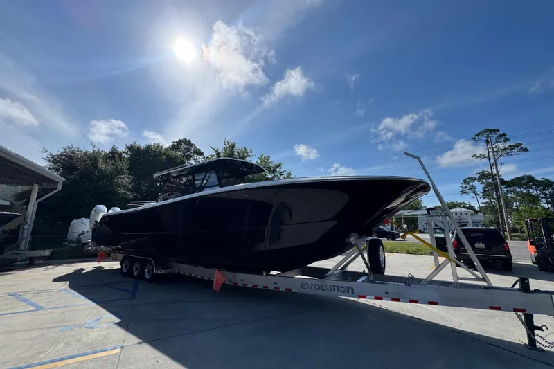 Slide: The Image of 2022 Invincible 46 Catamaran on trailer under sunny sky. - 6
