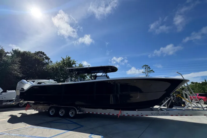 Slide: The Image of 2022 Invincible 46 Catamaran on trailer under clear blue sky. - 7