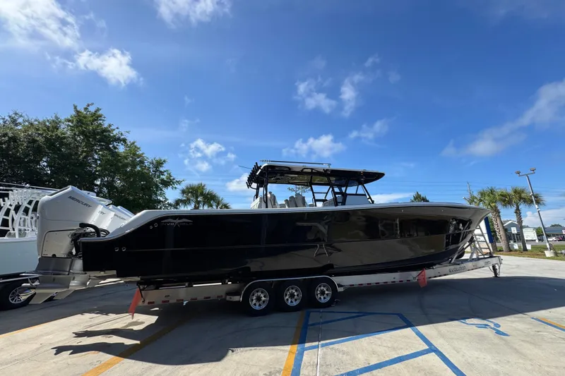 Slide: The Image of 2022 Invincible 46 Catamaran on trailer under clear blue sky. - 8