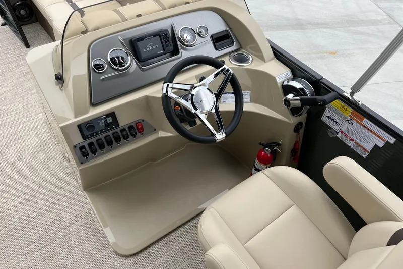 Slide: The Image of 2024 Crest Classic LX 220 SLRC boat dashboard with steering wheel and controls. - 10
