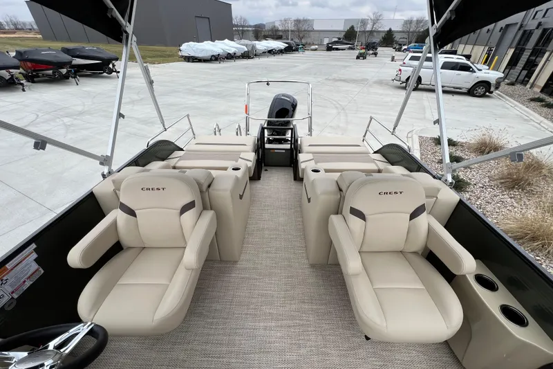 Slide: The Image of 2024 Crest Classic LX 220 SLRC pontoon boat with beige seating and modern design. - 11