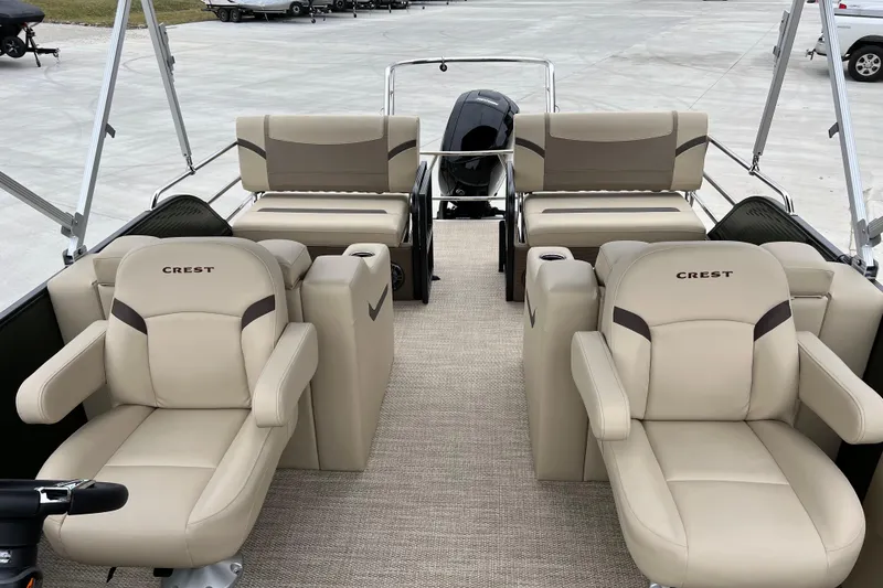 Slide: The Image of 2024 Crest Classic LX 220 SLRC pontoon boat with luxurious beige seating. - 12