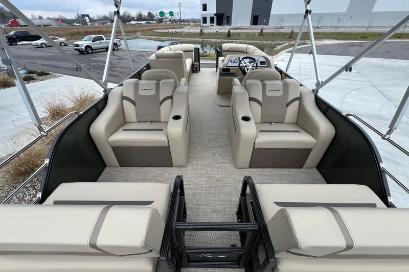 Slide: The Image of 2024 Crest Classic LX 220 SLRC pontoon boat with spacious seating and modern design. - 13