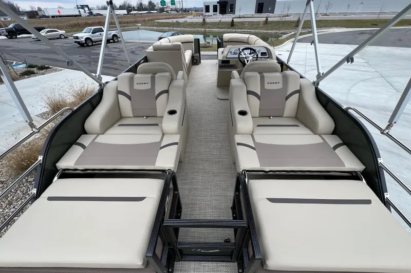 Slide: The Image of 2024 Crest Classic LX 220 SLRC pontoon boat with luxurious seating and modern design. - 14