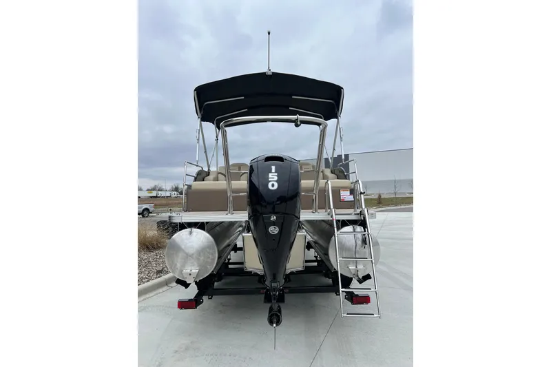 Slide: The Image of 2024 Crest Classic LX 220 SLRC pontoon boat, rear view with motor and ladder. - 3