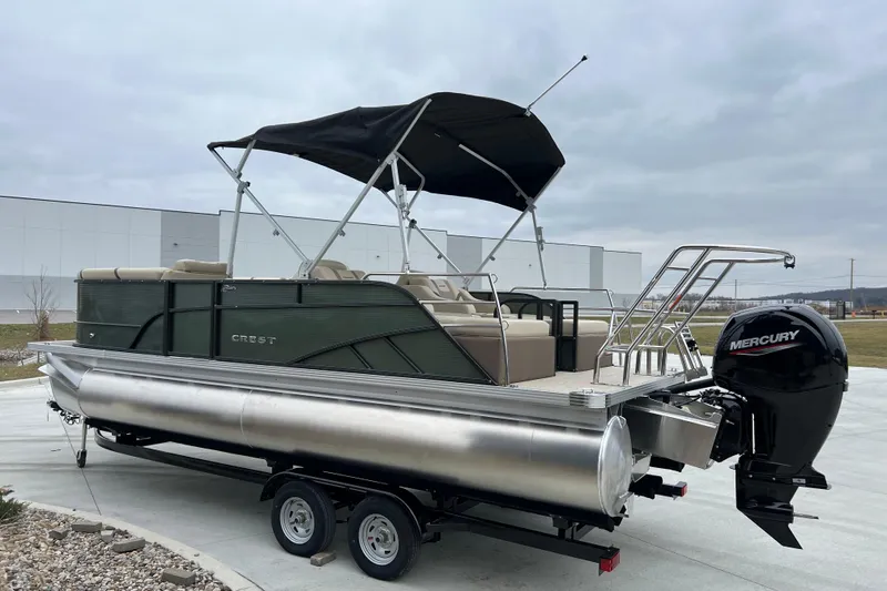 Slide: The Image of 2024 Crest Classic LX 220 SLRC pontoon boat with Mercury engine on trailer. - 4