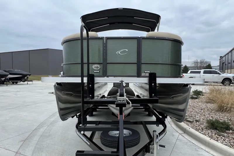 Slide: The Image of 2024 Crest Classic LX 220 SLRC pontoon boat on trailer, outdoor setting. - 7