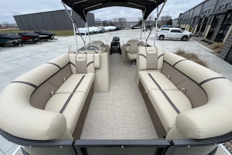Slide: The Image of 2024 Crest Classic LX 220 SLRC pontoon boat with spacious seating and modern design. - 8