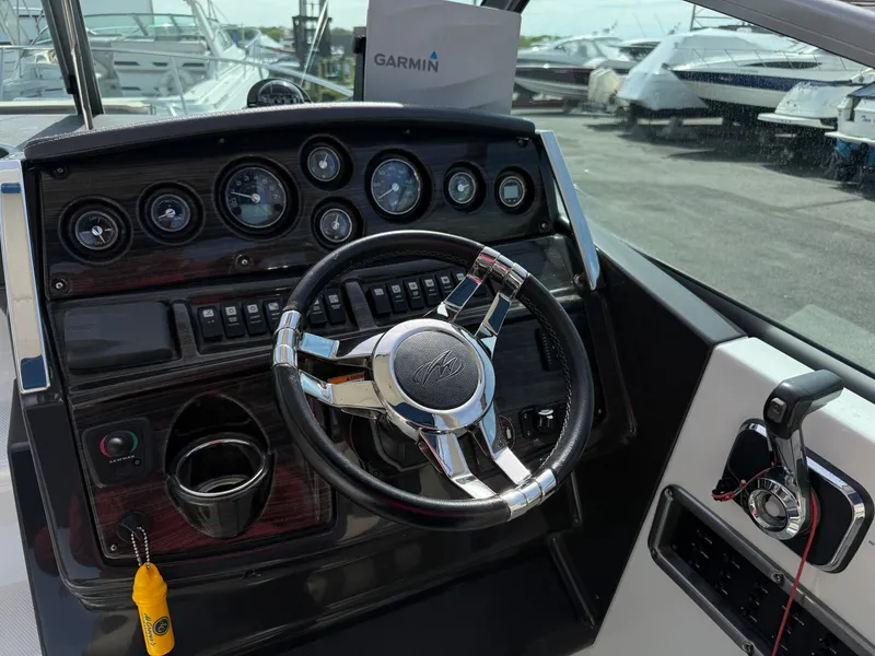 Slide: The Image of Cockpit of 2019 Monterey SPORT YACHT 295 with steering wheel and instruments. - 11