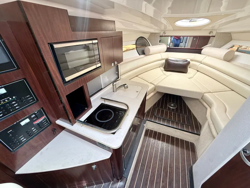 Slide: The Image of Interior of 2019 Monterey SPORT YACHT 295 with kitchen and seating area. - 15