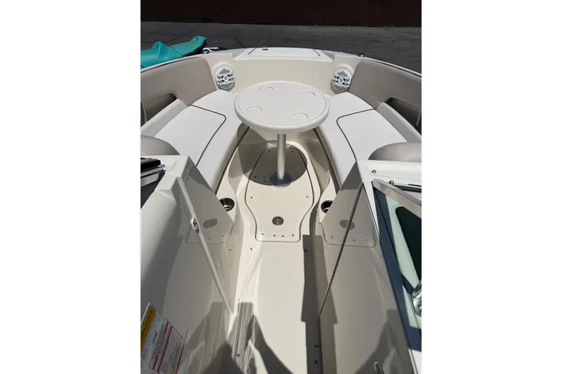 Slide: The Image of 2010 Sea Ray 230 Sundeck interior with seating and table, showcasing spacious design. - 14