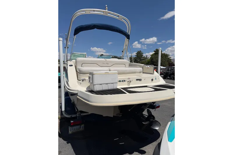 Slide: The Image of 2010 Sea Ray 230 Sundeck boat with swim platform and canopy under blue sky. - 5