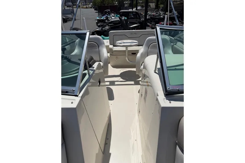 Slide: The Image of 2010 Sea Ray 230 Sundeck interior with seating and table, showcasing spacious design. - 7