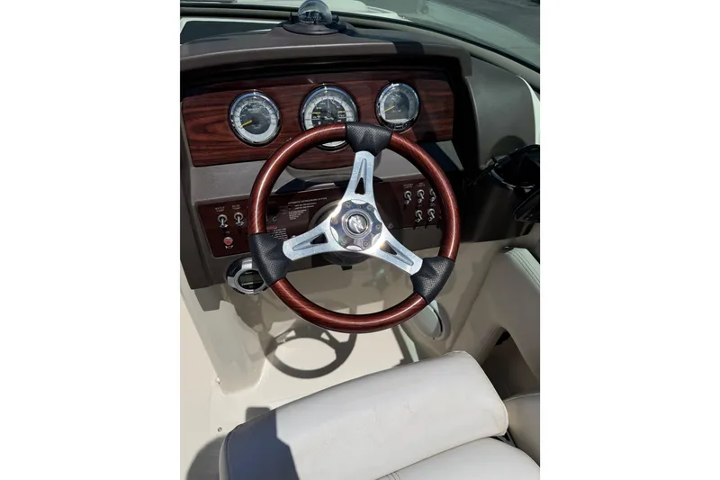 Slide: The Image of Steering wheel and dashboard of 2010 Sea Ray 230 Sundeck boat. - 8