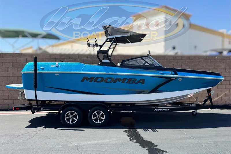 The Image of 2019 Moomba Max boat in vibrant blue on a trailer, displayed outdoors. - 0