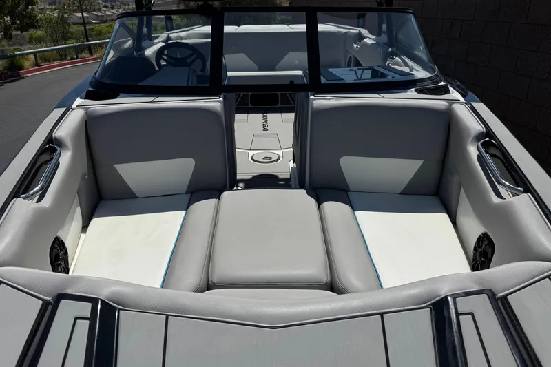 Slide: The Image of 2019 Moomba Max boat interior with gray and white seating, steering wheel visible. - 10