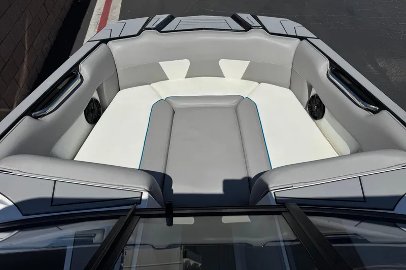Slide: The Image of 2019 Moomba Max boat interior with gray and white seating, featuring speakers and handles. - 11
