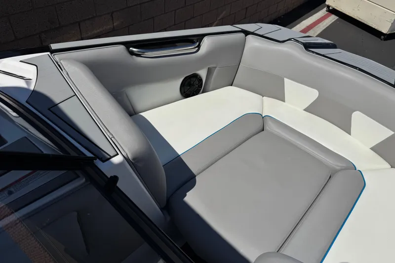 Slide: The Image of 2019 Moomba Max boat interior with gray and white seating, featuring a speaker. - 12