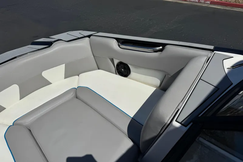 Slide: The Image of 2019 Moomba Max boat interior with gray and white seating, featuring a speaker. - 13