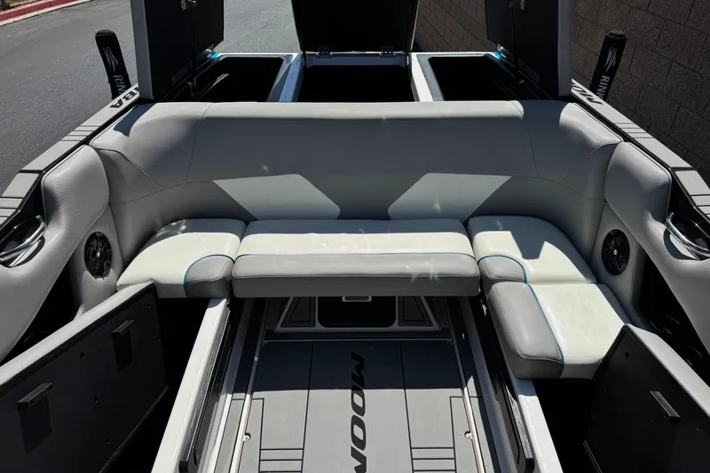 Slide: The Image of 2019 Moomba Max boat interior with gray seating and storage compartments. - 22