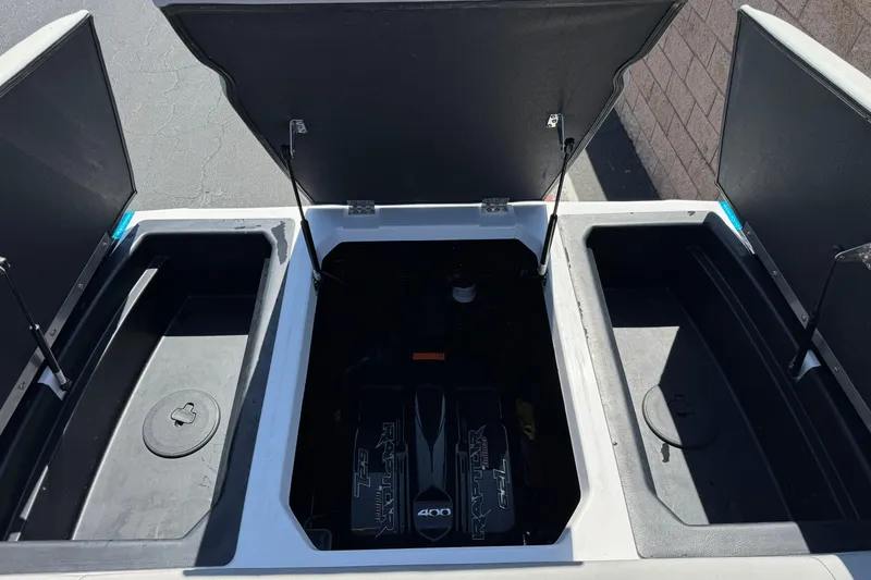 Slide: The Image of 2019 Moomba Max boat engine compartment with open storage hatches. - 23