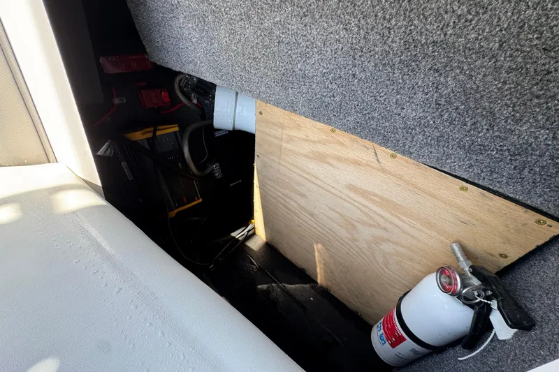 Slide: The Image of 2019 Moomba Max interior storage with fire extinguisher and equipment. - 27