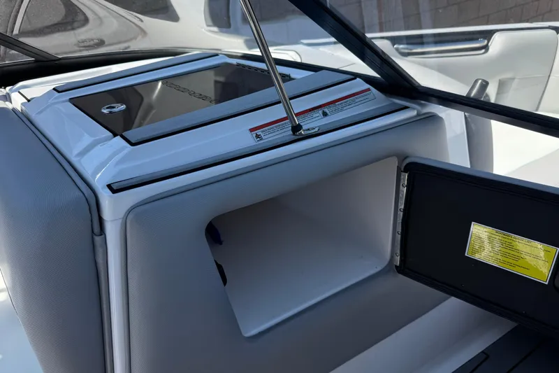 Slide: The Image of 2019 Moomba Max boat interior storage compartment with open hatch and sleek design. - 29
