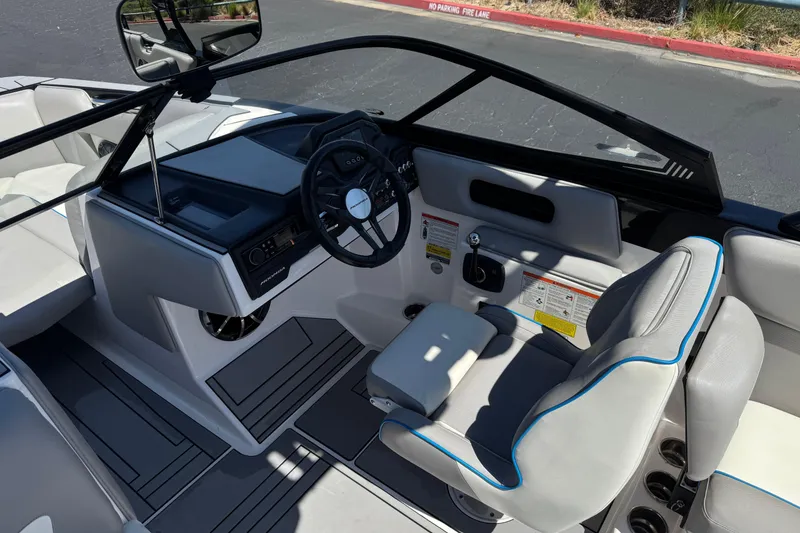 Slide: The Image of 2019 Moomba Max boat interior with steering wheel and seating area. - 30