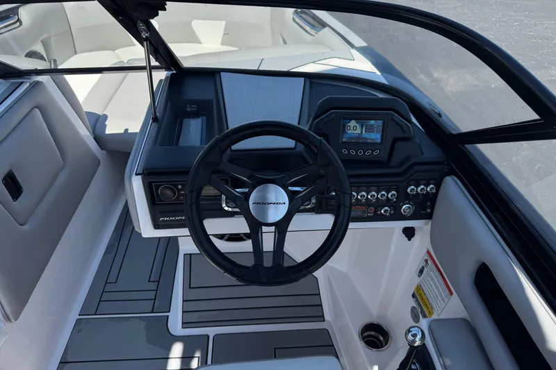 Slide: The Image of 2019 Moomba Max boat dashboard with steering wheel and control panel. - 31