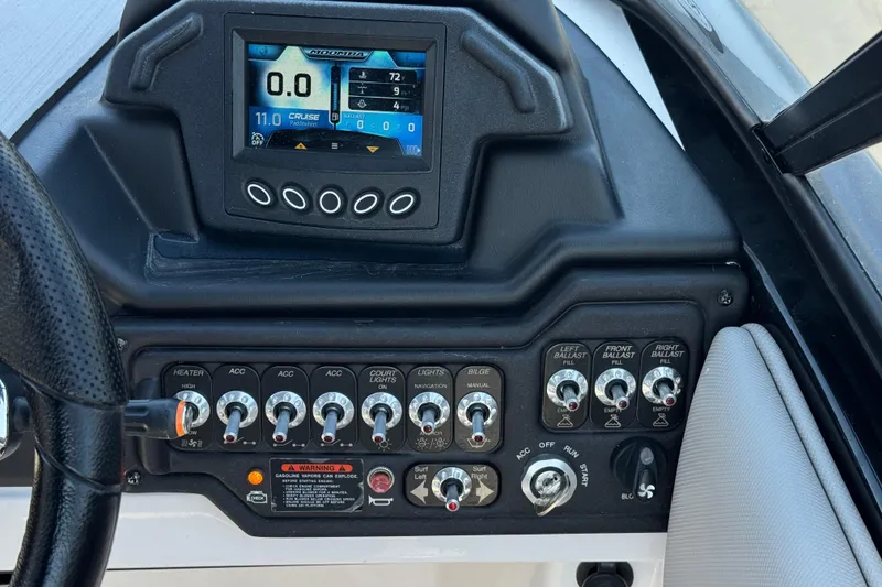Slide: The Image of Dashboard of a 2019 Moomba Max boat with control switches and digital display. - 32