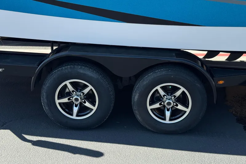 Slide: The Image of Trailer wheels of a 2019 Moomba Max boat on pavement. - 37