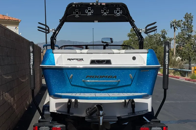 Slide: The Image of 2019 Moomba Max boat with blue glitter finish, parked on a trailer. - 4