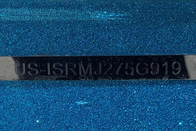 Slide: The Image of Close-up of a 2019 Moomba Max boat identification number on a sparkling blue surface. - 40