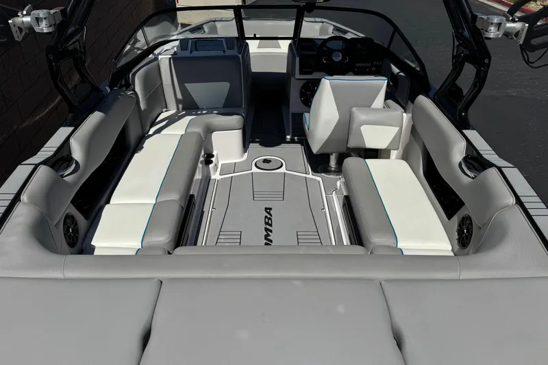Slide: The Image of 2019 Moomba Max boat interior with gray and white seating, modern dashboard, and spacious layout. - 9