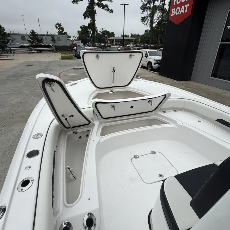 Slide: The Image of 2026 Tidewater 2500 Carolina Bay with open storage compartments at dock. - 22