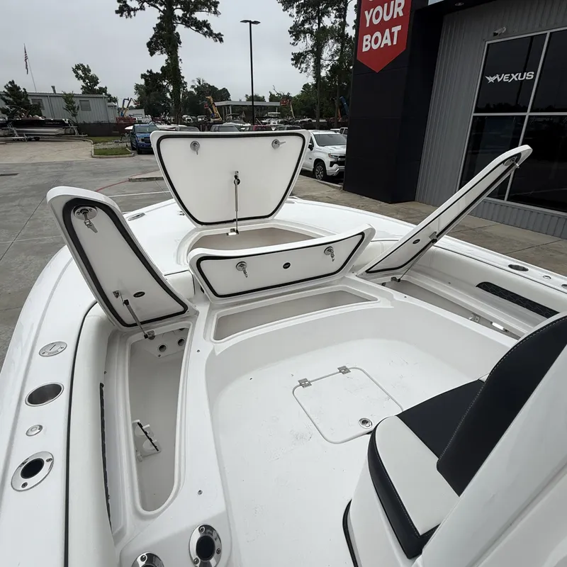 Slide: The Image of 2026 Tidewater 2500 Carolina Bay with open storage compartments. - 23