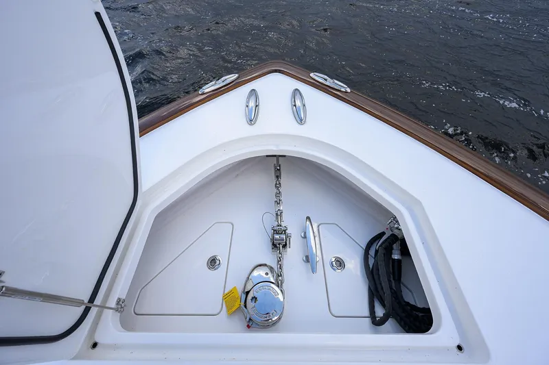 Slide: The Image of Valhalla V-46 2026 boat anchor compartment with chain and rope on water. - 11