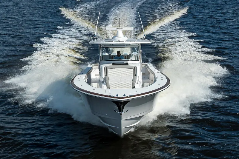 Slide: The Image of Valhalla V-46 boat cruising on water, 2026 model, front view. - 2