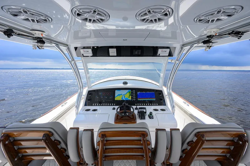 Slide: The Image of 2026 Valhalla V-46 boat cockpit with advanced navigation systems and luxurious seating on open water. - 22