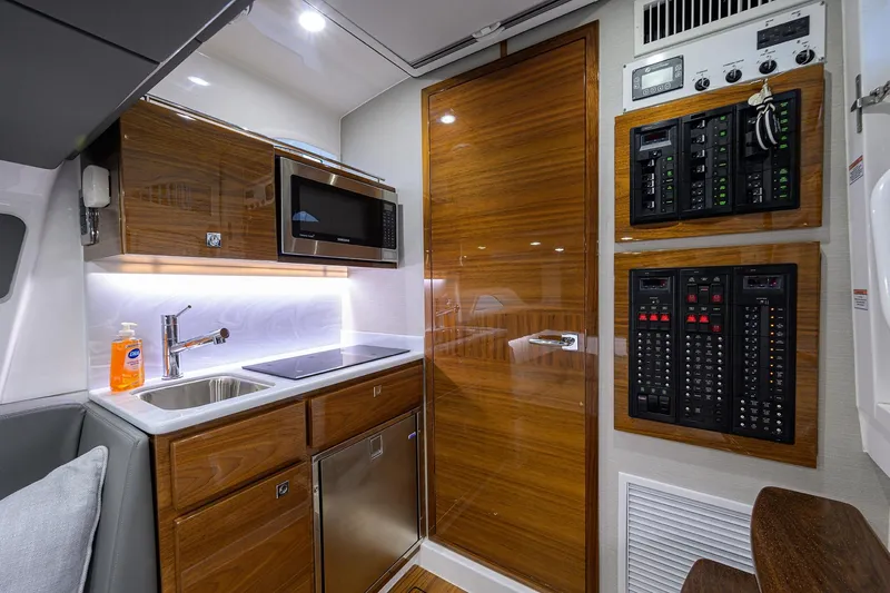 Slide: The Image of Modern kitchen area in 2026 Valhalla V-46 yacht with wood cabinets and control panels. - 25