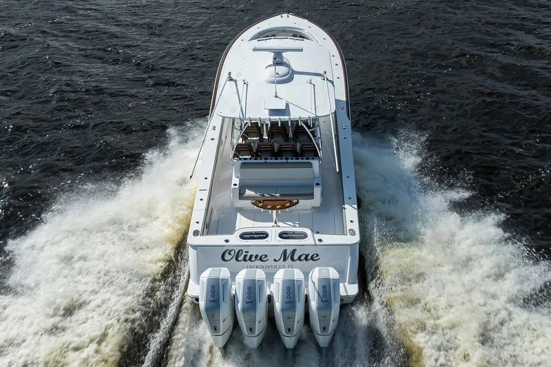 Slide: The Image of 2026 Valhalla V-46 boat cruising on water, rear view with four engines. - 3